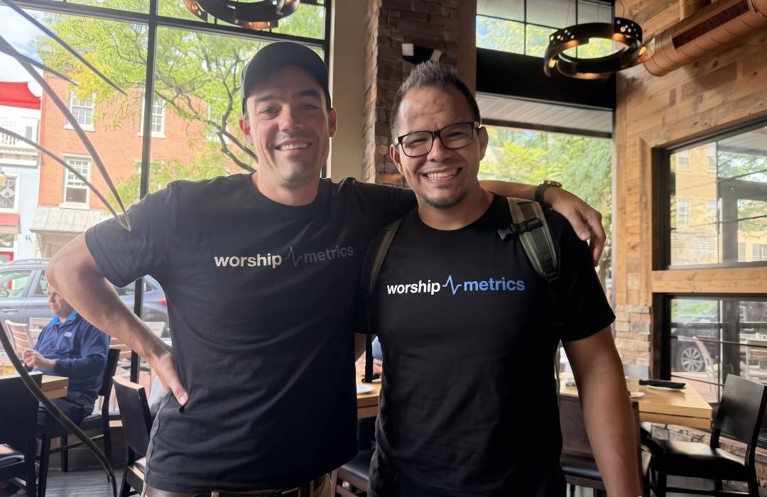 Two members of the WorshipMetrics team in matching WorshipMetrics T-shirts